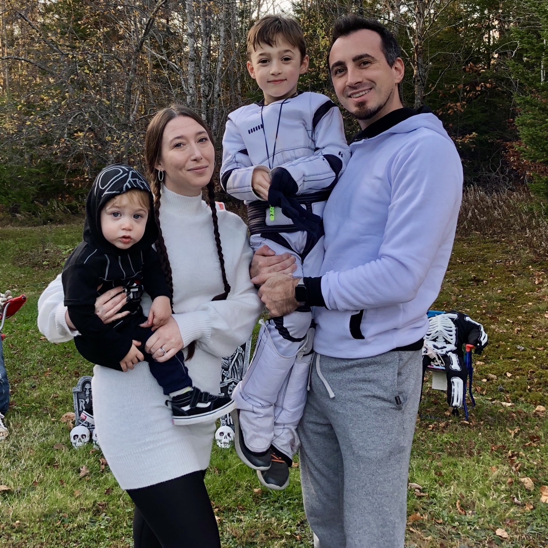 Chesley with his wife and two children outdoors in the fall
